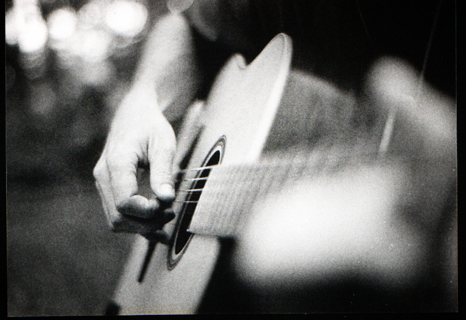 black and white guitar player. A solo guitar player, a small summer stroll in the south of France. Black 